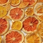 A colorful arrangement of dried citrus fruit slices creating a vibrant texture.