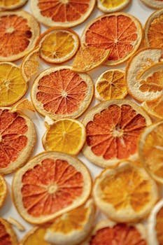 A colorful arrangement of dried citrus fruit slices creating a vibrant texture.