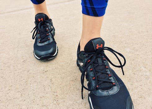 Close-up view of a person wearing black athletic sneakers on pavement, highlighting fitness and exercise.